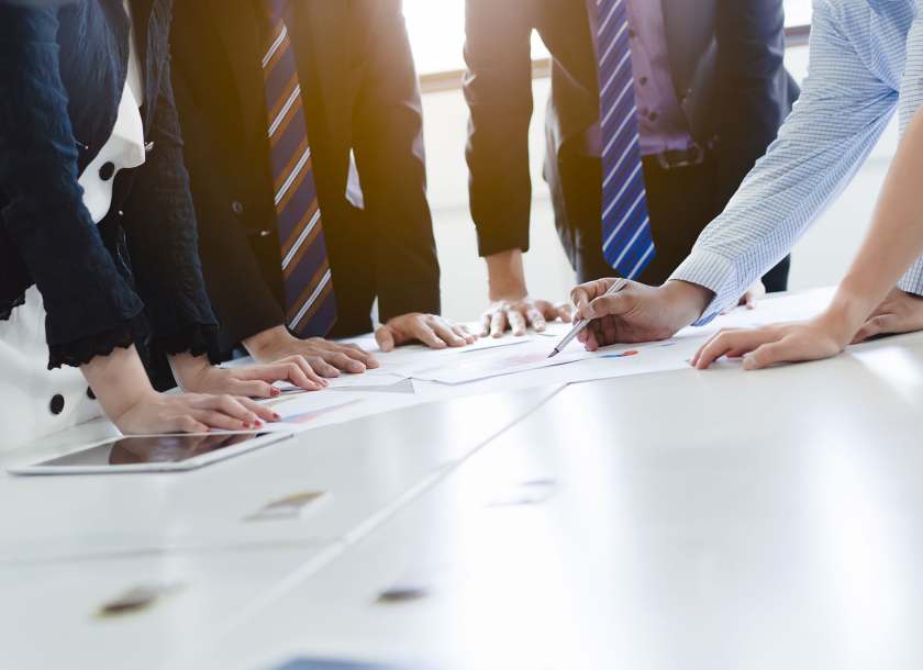 Business executives discuss manufacturing strategy at a meetingsherpany